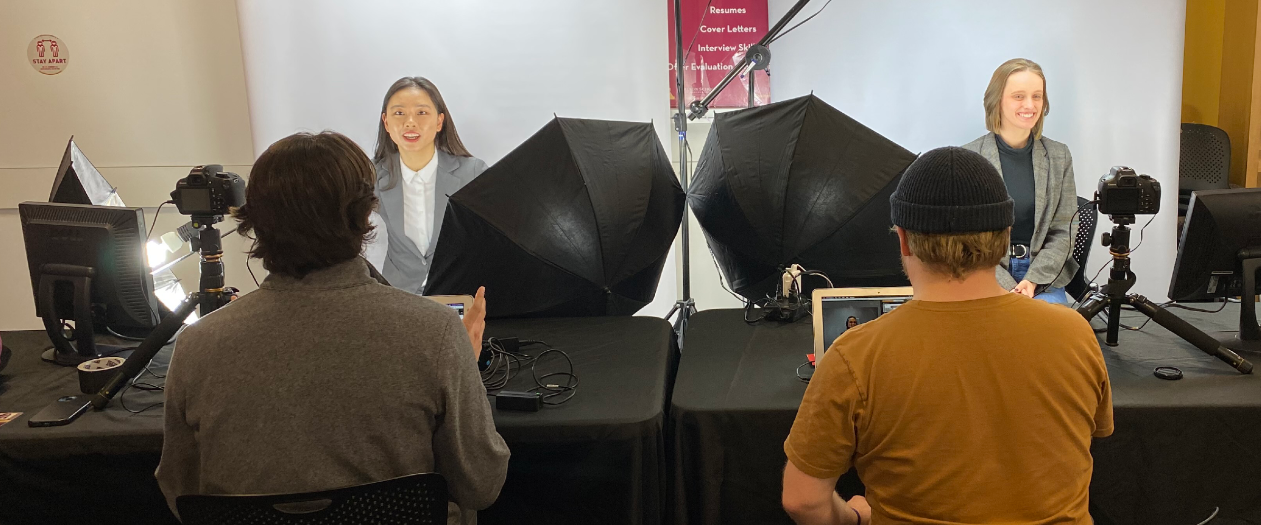 2 students having their headshot taken at an event
